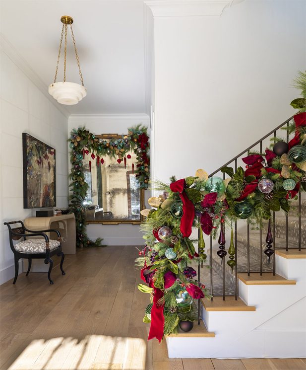 Professional Decorated Staircase in a Residential Home with Garlands. Decorated Mirror with Garlands.