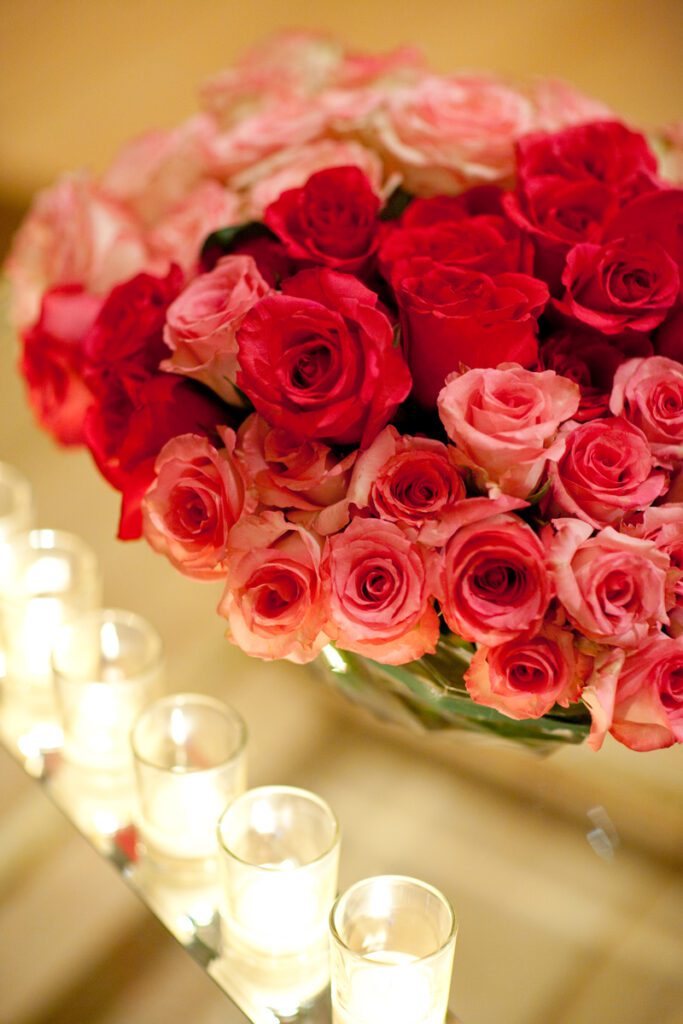 Colorful floral centerpiece of roses and candles.