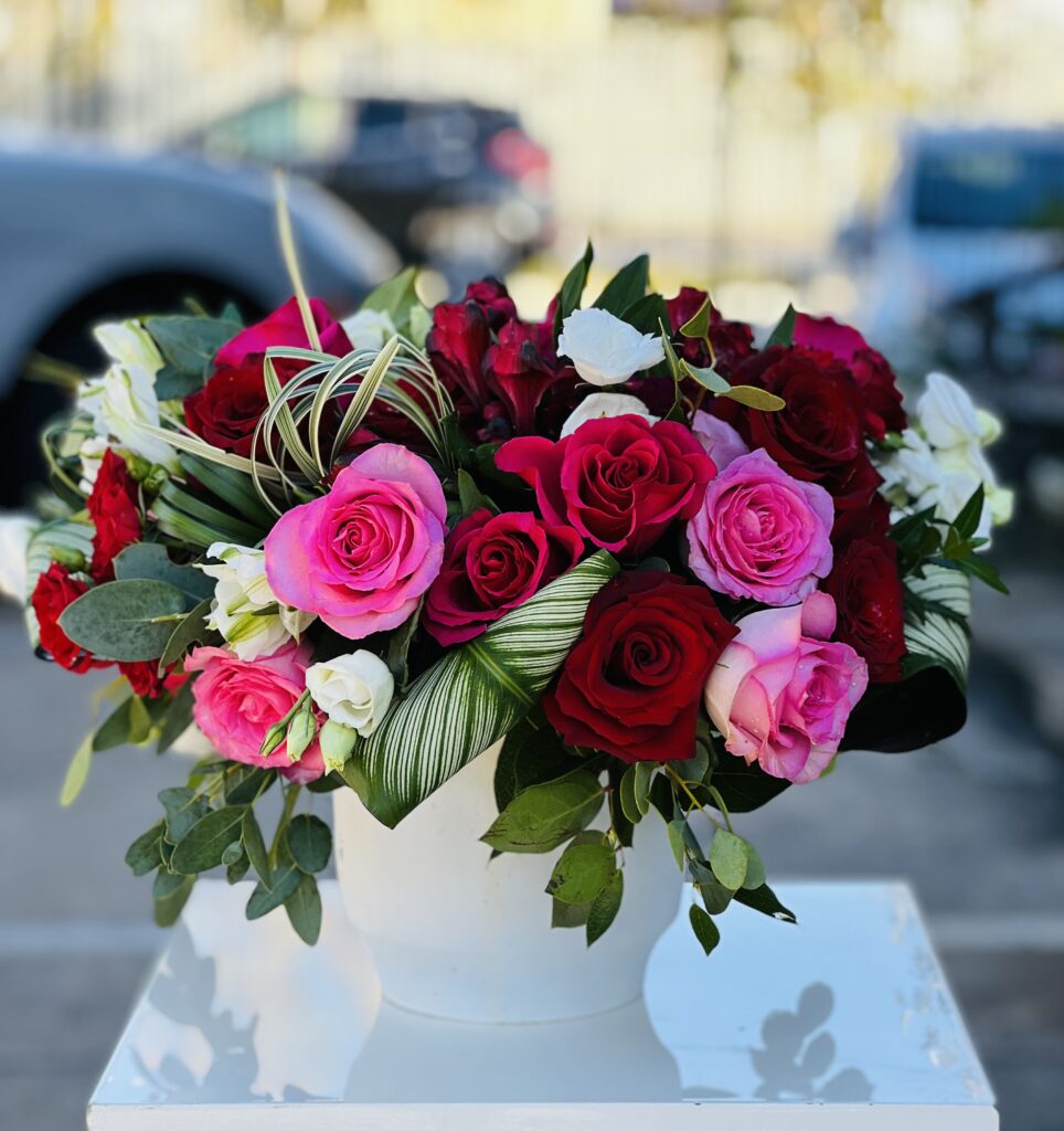 Floral subscription arrangement of pink and red roses.