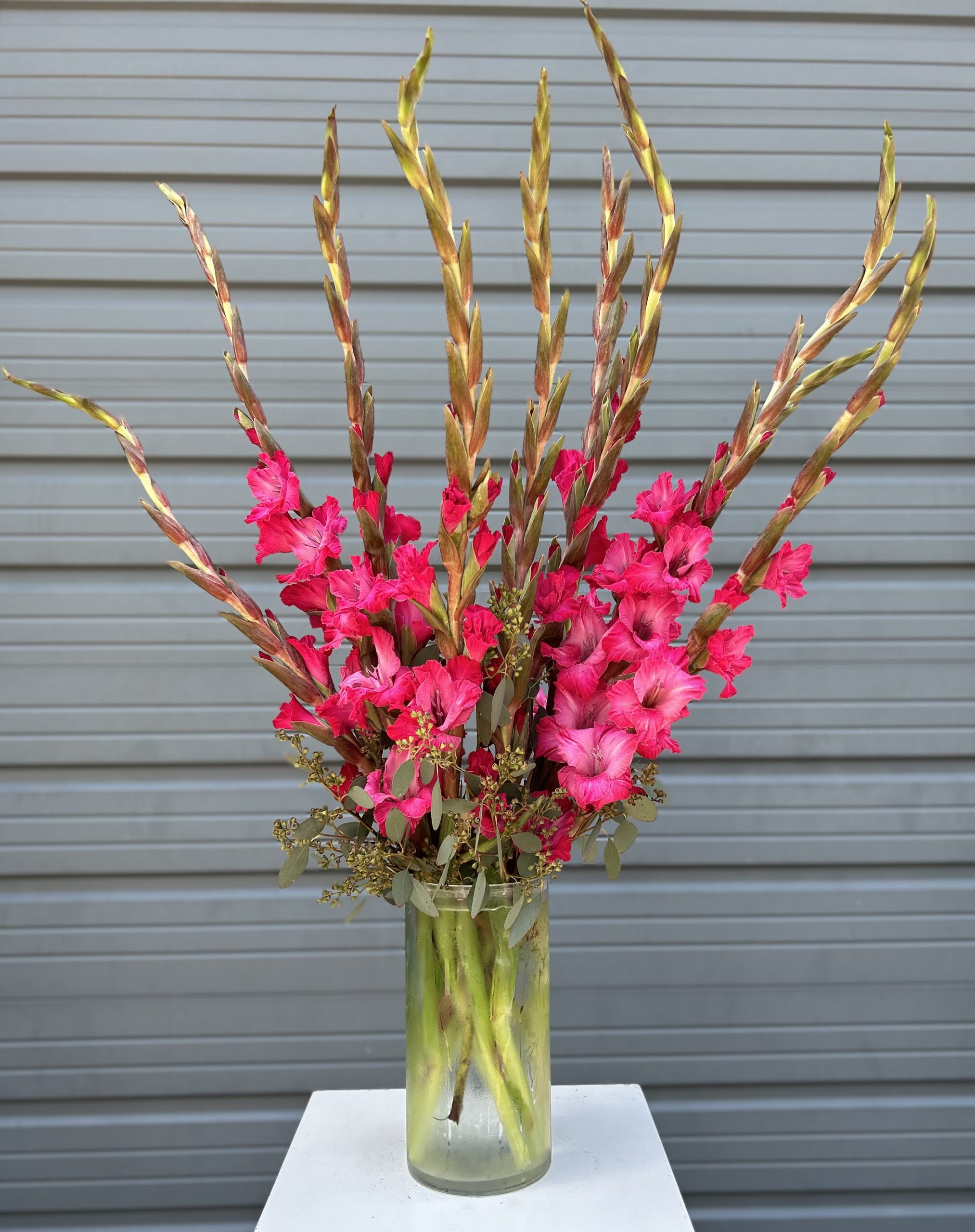 Floral subscription arrangement of bright pink flowers.